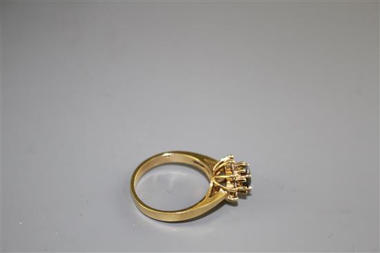 A modern 18k yellow metal, chrysoberyl? and diamond set oval cluster ring, size M, gross weight 4.2 grams.
